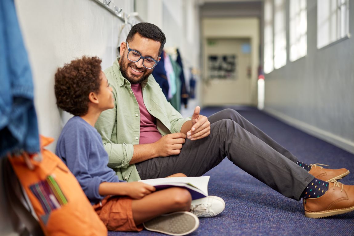 man sitting talking with child